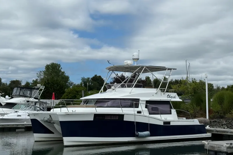 Slide: The Image of 2015 Fountaine Pajot Summerland 40 LC catamaran docked at marina under cloudy sky. - 5