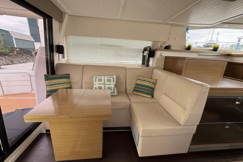 Slide: The Image of Interior of 2015 Fountaine Pajot Summerland 40 LC with cozy seating and wooden table. - 56