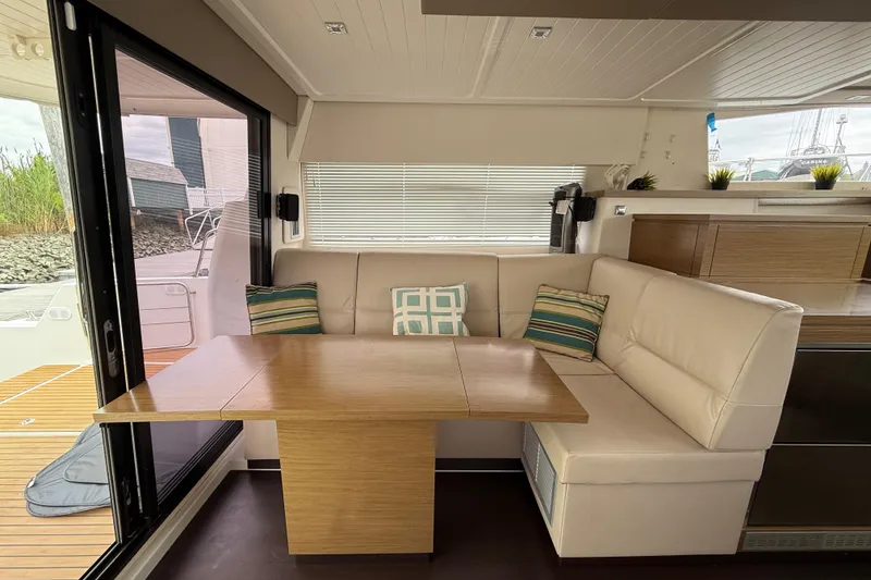 Slide: The Image of Interior of 2015 Fountaine Pajot Summerland 40 LC with cozy seating and wooden table. - 57