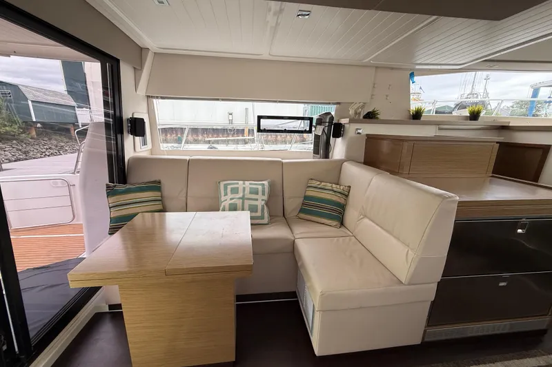 Slide: The Image of Interior of 2015 Fountaine Pajot Summerland 40 LC with cozy seating and table. - 60