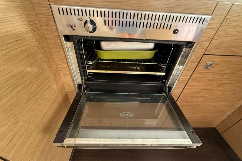 Slide: The Image of Open oven with baking dish inside on Fountaine Pajot Summerland 40 LC yacht, 2015 model. - 63