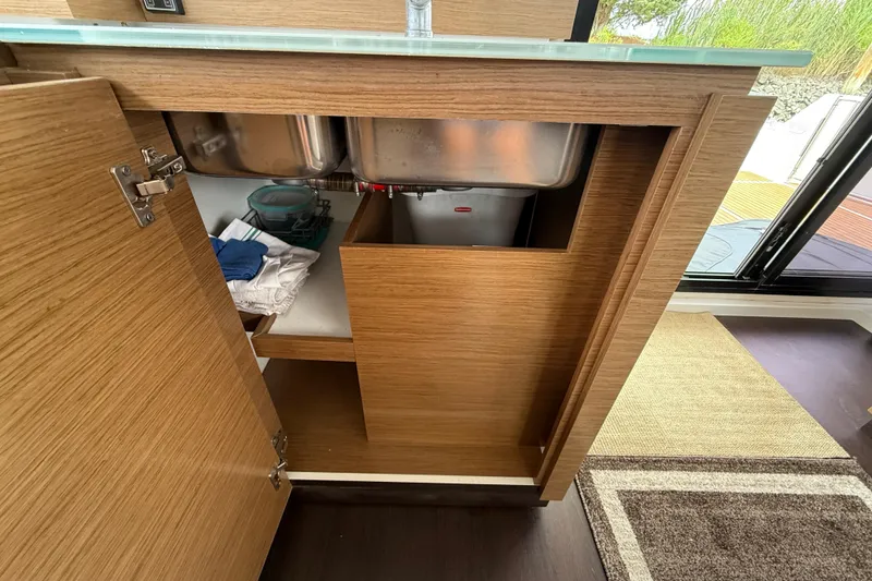 Slide: The Image of Interior view of 2015 Fountaine Pajot Summerland 40 LC kitchen cabinet with open doors. - 65