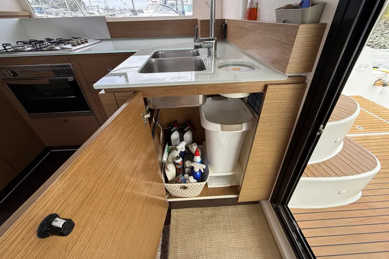 Slide: The Image of Modern kitchen on 2015 Fountaine Pajot Summerland 40 LC yacht with open cabinet storage. - 66