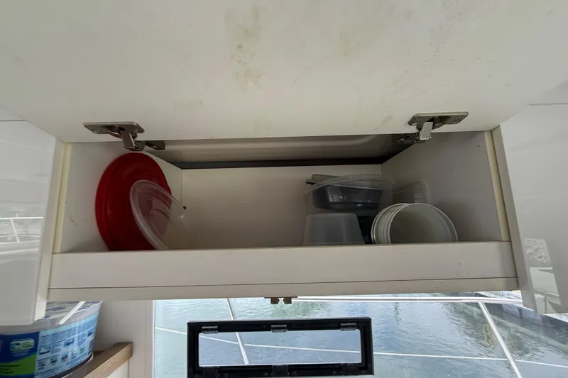 Slide: The Image of Open cabinet with plastic containers on Fountaine Pajot Summerland 40 LC, 2015 model. - 69