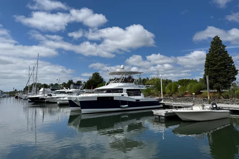 Slide: The Image of 2015 Fountaine Pajot Summerland 40 LC catamaran docked at a marina under blue skies. - 7