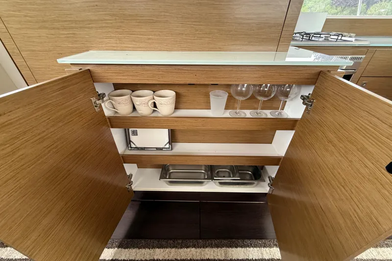 Slide: The Image of Open wooden cabinet in 2015 Fountaine Pajot Summerland 40 LC yacht kitchen. - 73