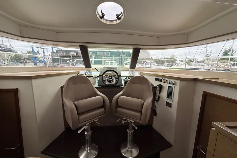 Slide: The Image of Helm station of 2015 Fountaine Pajot Summerland 40 LC with dual seats and panoramic view. - 77