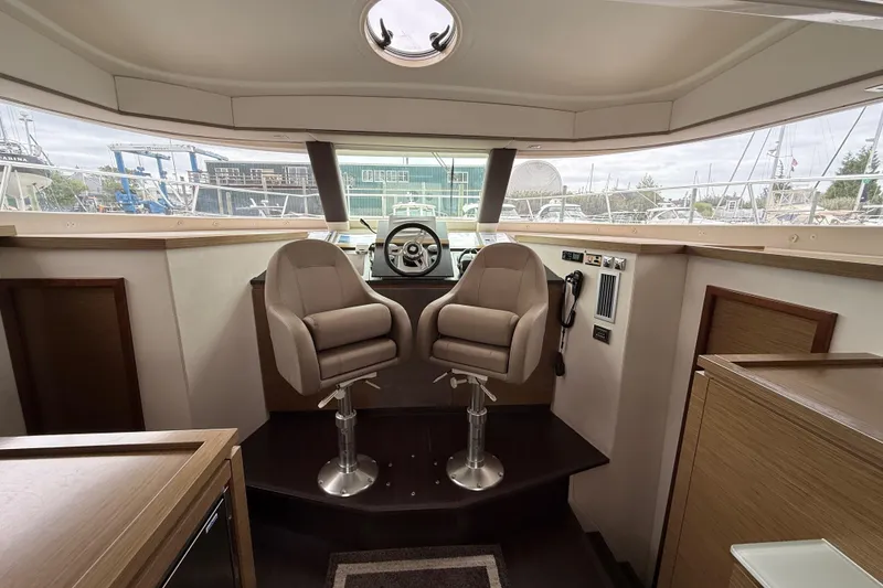 Slide: The Image of Interior helm of 2015 Fountaine Pajot Summerland 40 LC with dual captain chairs. - 78