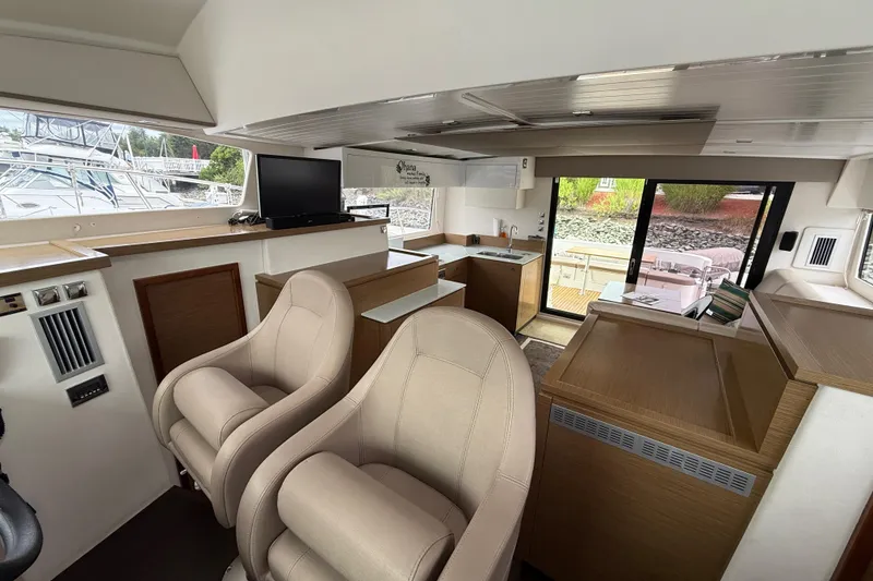 Slide: The Image of Interior of 2015 Fountaine Pajot Summerland 40 LC yacht, featuring modern seating and kitchen area. - 86
