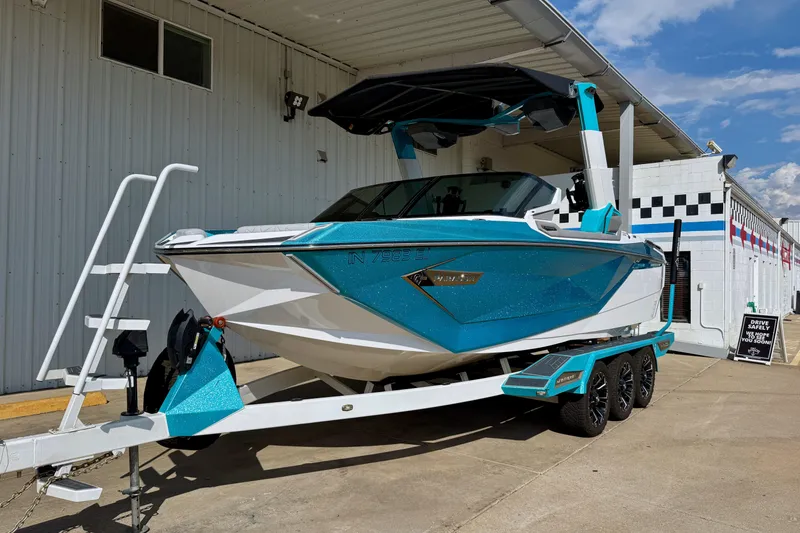 Slide: The Image of 2021 Nautique Super Air Nautique G23 Paragon boat on trailer, parked outdoors. - 1