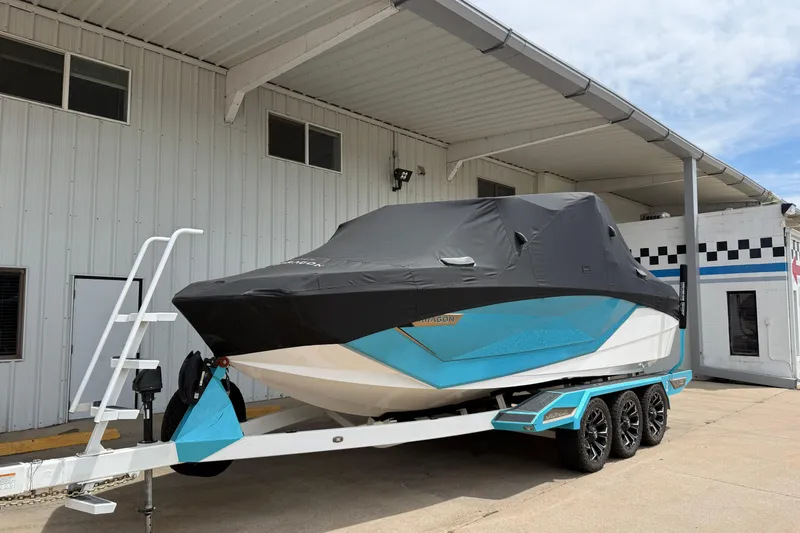 Slide: The Image of 2021 Nautique Super Air Nautique G23 Paragon boat covered on trailer, parked outside. - 10