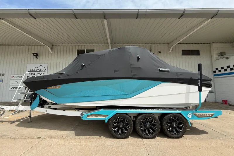 Slide: The Image of 2021 Nautique Super Air Nautique G23 Paragon boat with cover on trailer. - 11
