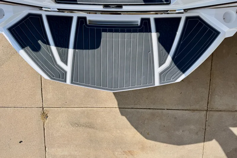 Slide: The Image of 2021 Nautique Super Air Nautique G23 Paragon swim platform, top view, on concrete surface. - 12