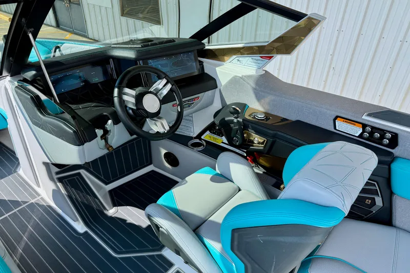 Slide: The Image of Interior of 2021 Nautique Super Air Nautique G23 Paragon boat, featuring modern dashboard and seating. - 15