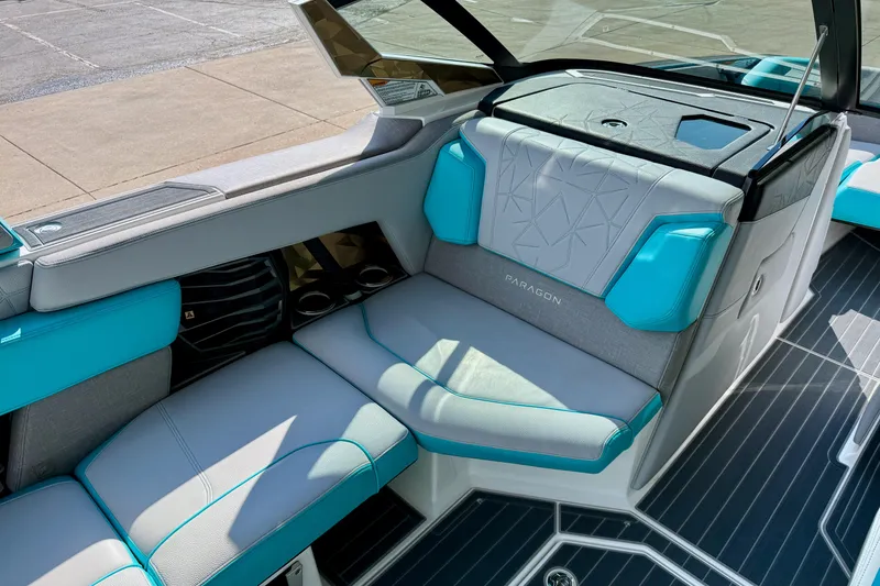 Slide: The Image of 2021 Nautique Super Air Nautique G23 Paragon interior with teal and gray seating. - 16