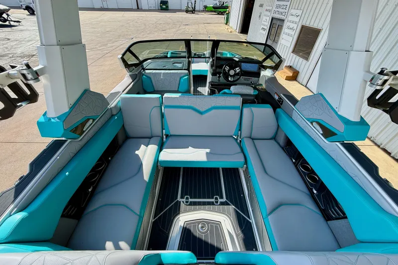 Slide: The Image of 2021 Nautique Super Air Nautique G23 Paragon interior with teal and gray seating. - 17