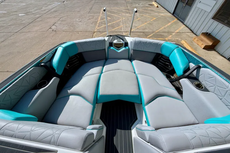 Slide: The Image of 2021 Nautique Super Air Nautique G23 Paragon boat interior with teal and gray seating. - 20