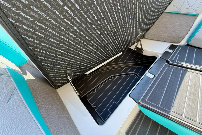 Slide: The Image of 2021 Nautique Super Air Nautique G23 Paragon interior storage compartment with branded upholstery. - 23