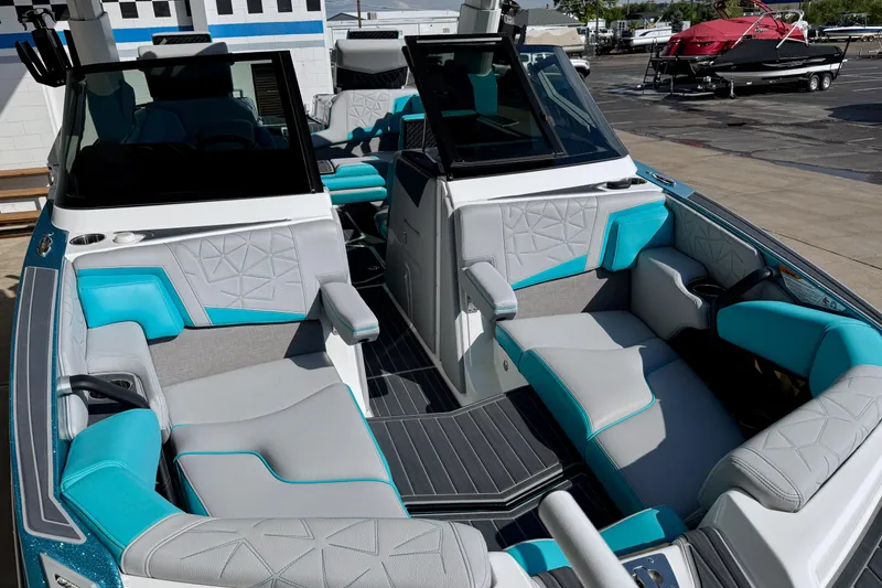 Slide: The Image of 2021 Nautique Super Air Nautique G23 Paragon interior with teal and gray seating. - 26