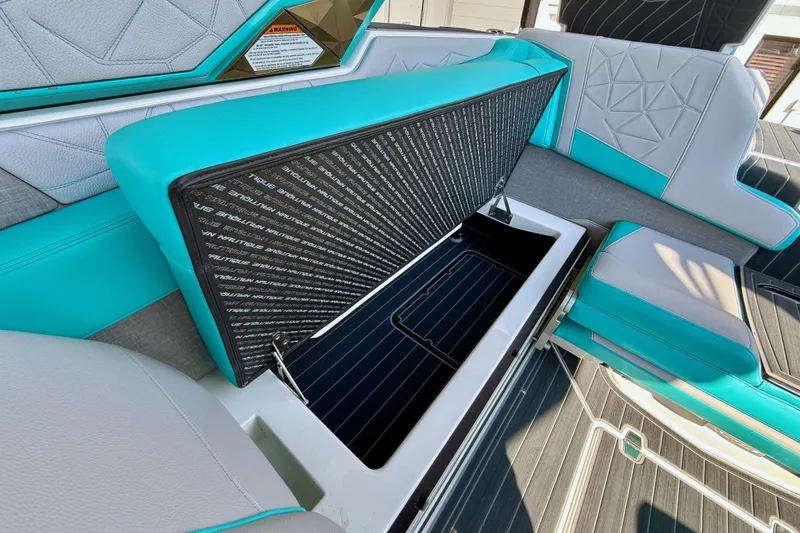 Slide: The Image of 2021 Nautique Super Air Nautique G23 Paragon interior storage compartment with teal and gray seating. - 27