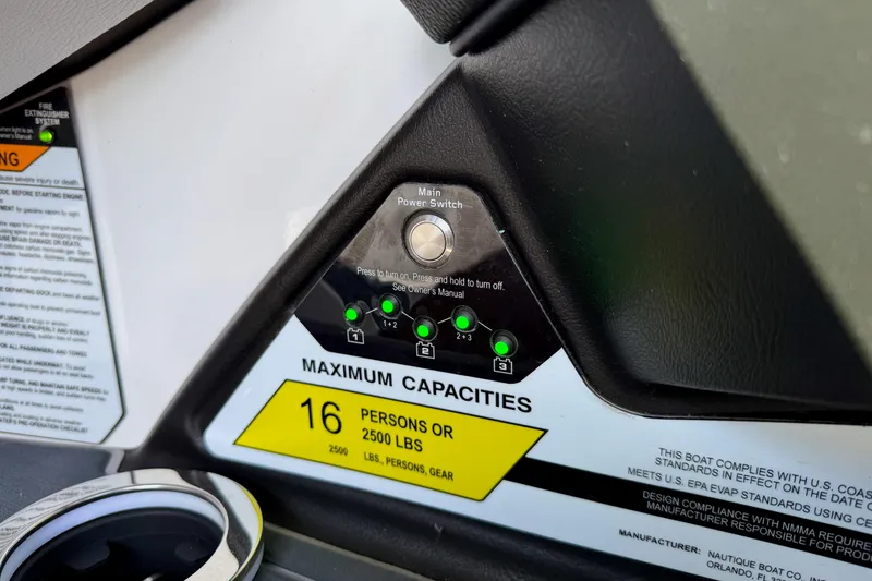 Slide: The Image of 2021 Nautique Super Air Nautique G23 Paragon control panel with capacity warning label. - 41