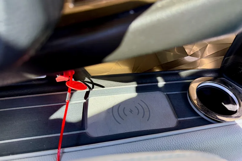 Slide: The Image of 2021 Nautique Super Air Nautique G23 Paragon interior with wireless charging pad and cup holder. - 42