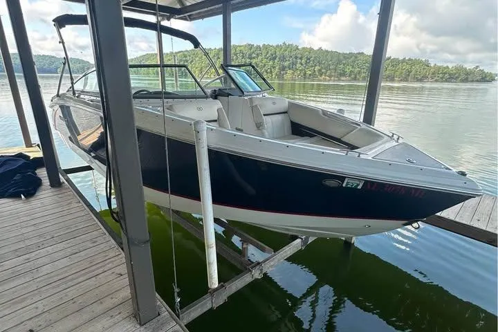 Slide: The Image of 2014 Cobalt R5 boat docked on a lake with scenic forest background. - 2