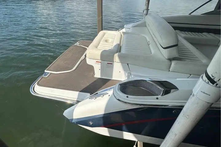 Slide: The Image of 2014 Cobalt R5 boat with white seating and swim platform on calm water. - 8