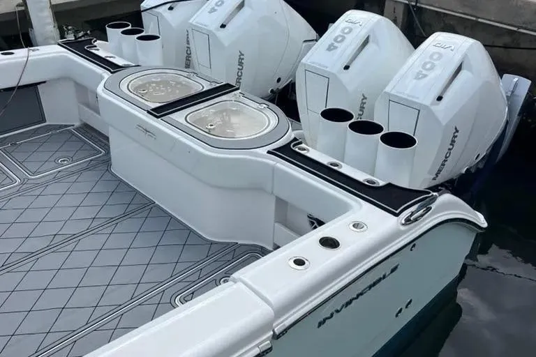 Slide: The Image of 2020 Invincible 40 Catamaran with Mercury outboard engines, docked at marina. - 13