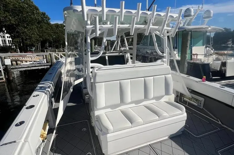 Slide: The Image of 2020 Invincible 40 Catamaran with white seating and rod holders at a marina. - 14