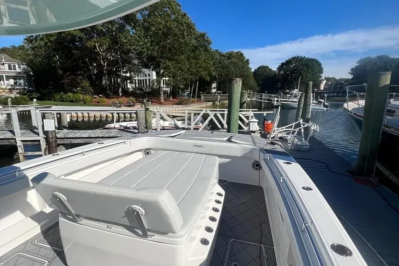 Slide: The Image of Invincible 40 Catamaran 2020 docked at a scenic marina with lush greenery. - 15