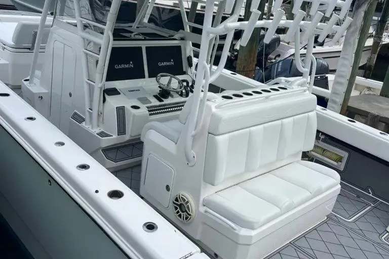 Slide: The Image of 2020 Invincible 40 Catamaran interior with white seating and Garmin navigation system. - 20