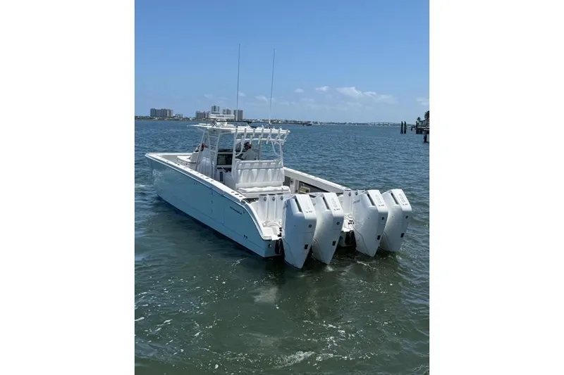 Slide: The Image of 2020 Invincible 40 Catamaran with multiple outboard engines on the water. - 4