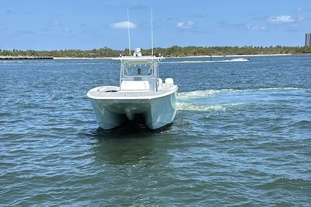 Slide: The Image of 2020 Invincible 40 Catamaran cruising on open water under a clear blue sky. - 5