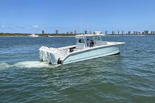 Slide: The Image of 2020 Invincible 40 Catamaran cruising on a sunny day near a city skyline. - 7