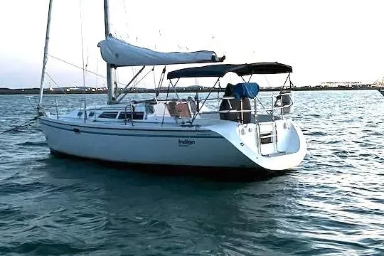 The Image of Sailboat Catalina 320, 1994 model, anchored on calm waters at sunset. - 0