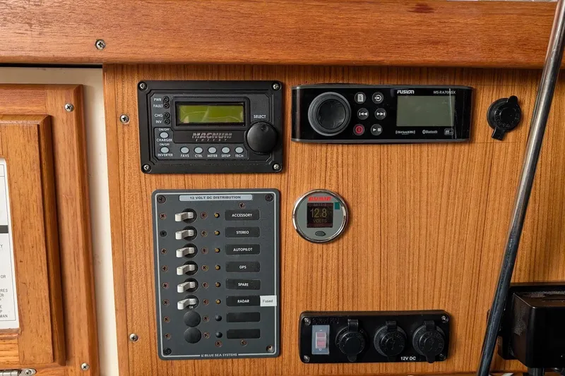Slide: The Image of Control panel of a 1994 Catalina 320 sailboat with various electronic devices. - 9