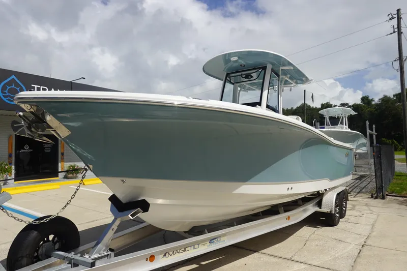 Slide: The Image of 2026 Sea Hunt Gamefish 27 Coffin Box boat on trailer, parked outdoors. - 2