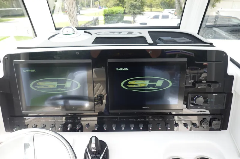 Slide: The Image of 2026 Sea Hunt Gamefish 27 Coffin Box dashboard with dual Garmin displays and controls. - 20