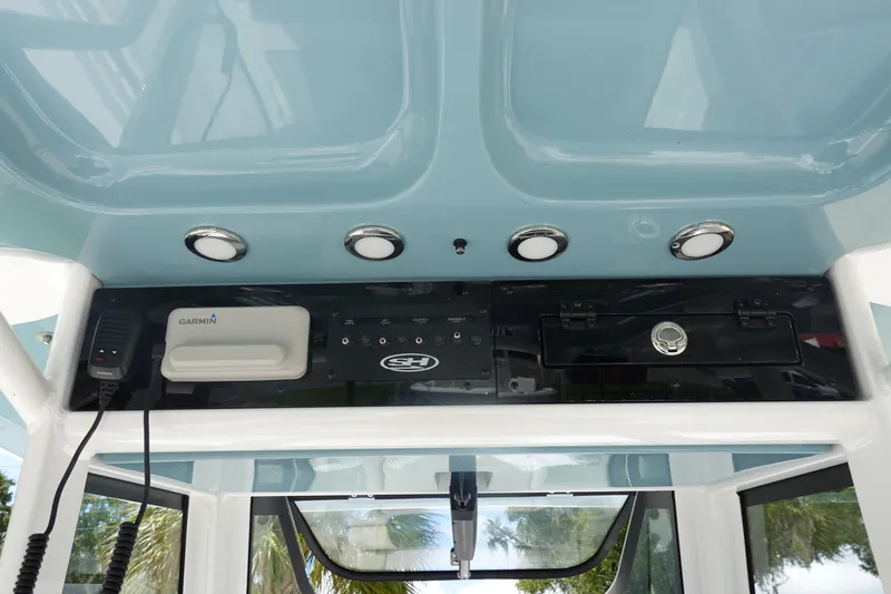 Slide: The Image of 2026 Sea Hunt Gamefish 27 Coffin Box console with Garmin electronics and overhead lighting. - 22