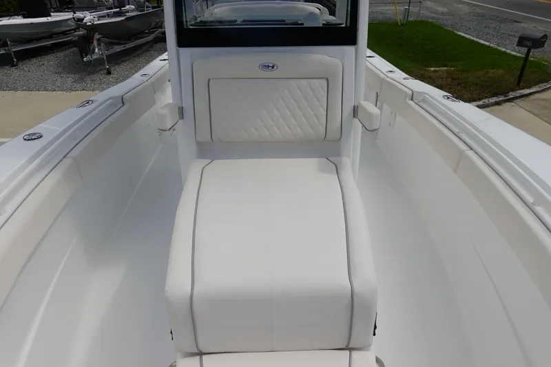 Slide: The Image of 2026 Sea Hunt Gamefish 27 Coffin Box boat interior with white seating and storage. - 24