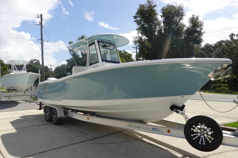 Slide: The Image of 2026 Sea Hunt Gamefish 27 Coffin Box boat on trailer, parked outdoors. - 4