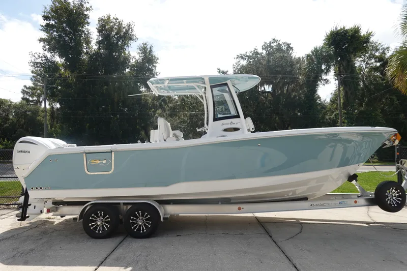 Slide: The Image of 2026 Sea Hunt Gamefish 27 Coffin Box boat on trailer, side view, outdoors. - 5