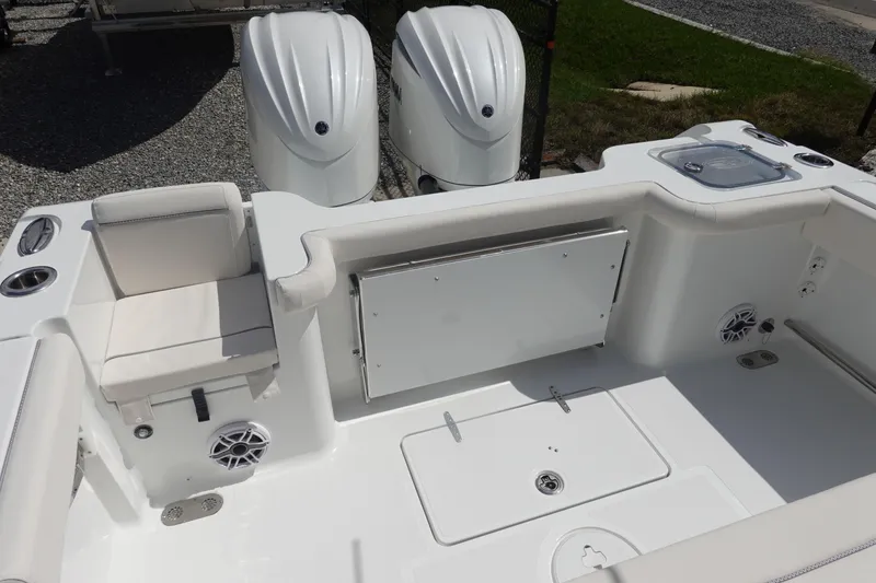 Slide: The Image of 2026 Sea Hunt Gamefish 27 Coffin Box boat interior with seating and dual engines. - 8