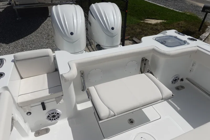 Slide: The Image of 2026 Sea Hunt Gamefish 27 Coffin Box boat interior with seating and dual engines. - 9
