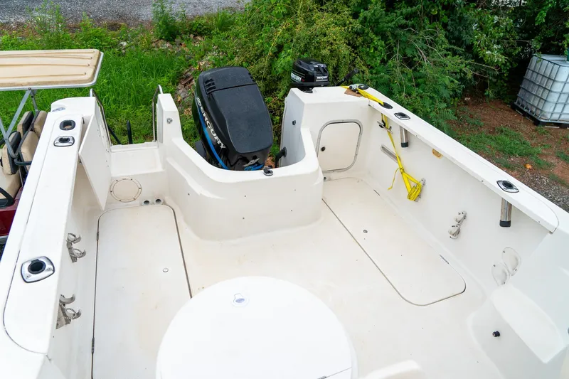 Slide: The Image of 2002 Bayliner 2302 Trophy Walkaround boat interior with Mercury outboard motor. - 11