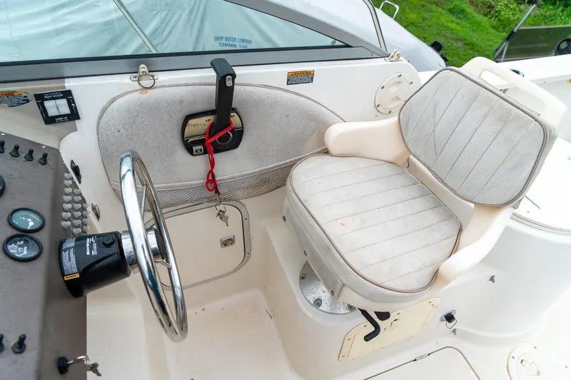Slide: The Image of Steering area of 2002 Bayliner 2302 Trophy Walkaround boat with captain's chair and controls. - 17