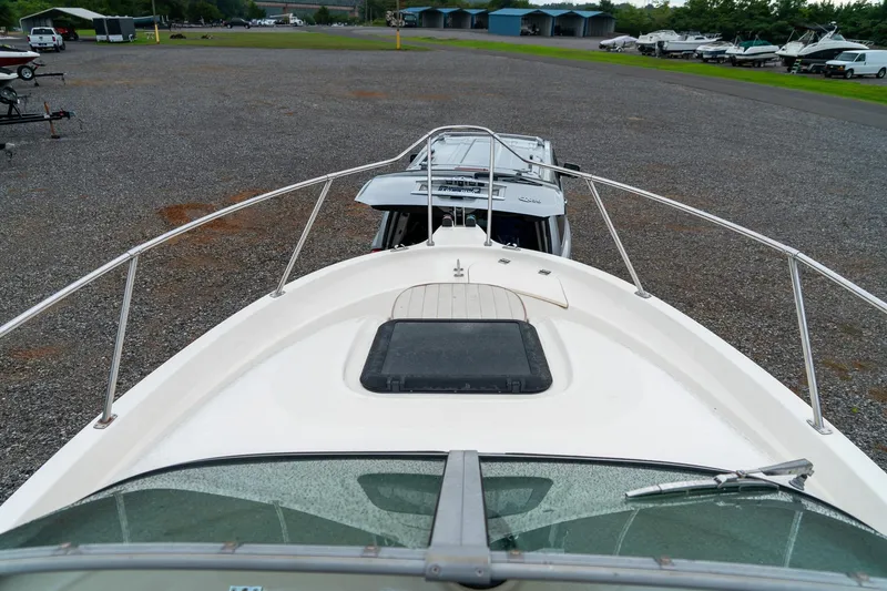 Slide: The Image of 2002 Bayliner 2302 Trophy Walkaround boat on gravel lot, view from bow. - 21