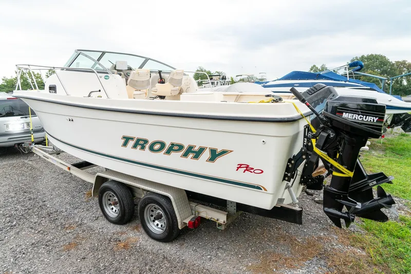 Slide: The Image of 2002 Bayliner 2302 Trophy Walkaround boat on trailer with Mercury outboard engine. - 3