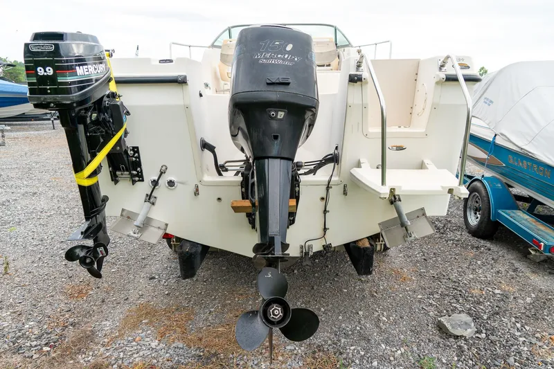 Slide: The Image of 2002 Bayliner 2302 Trophy Walkaround with dual outboard motors on gravel. - 8